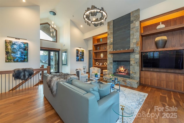 158 Riverbend Forest Dr Unit 15, Asheville, NC 28805 - living area featuring a chandelier, wood finished floors, a fireplace, and high vaulted ceiling