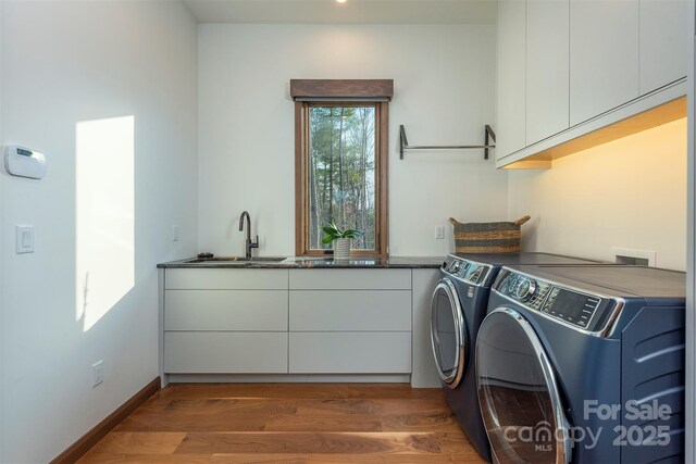158 Riverbend Forest Dr Unit 15, Asheville, NC 28805 - washroom with cabinet space, independent washer and dryer, wood finished floors, and baseboards
