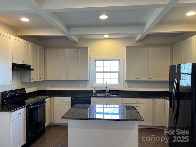 kitchen featuring under cabinet range hood, a sink, coffered ceiling, and black appliances