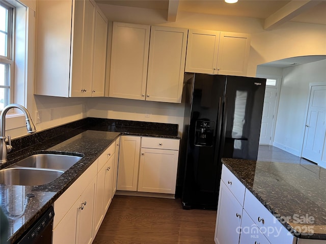kitchen featuring dark wood-style flooring, dark stone countertops, white cabinetry, a sink, and black appliances