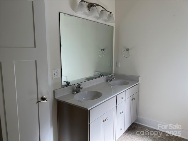 bathroom featuring double vanity, a sink, and tile patterned flooring