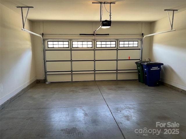 garage featuring baseboards and a garage door opener