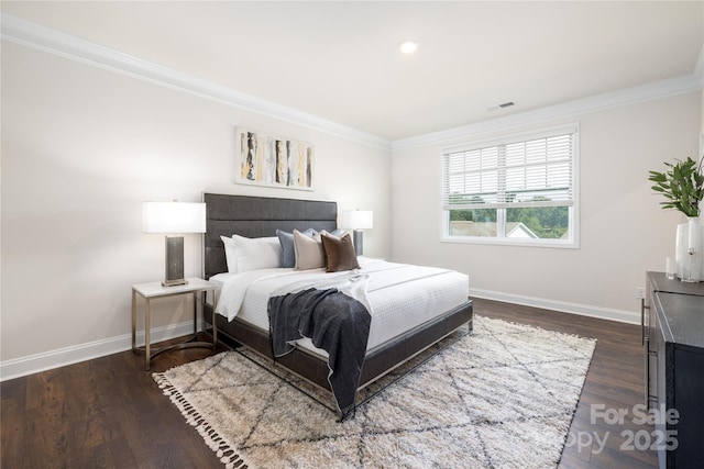 bedroom with dark wood-style flooring, baseboards, and crown molding