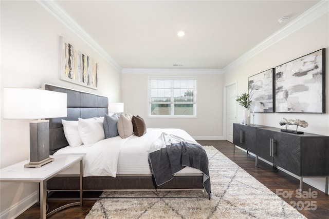 bedroom with wood finished floors, baseboards, ornamental molding, and visible vents