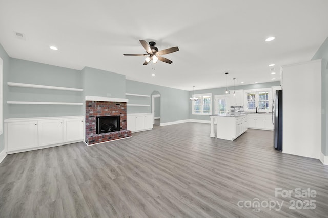 1380 Bowers Rd, Peachland, NC 28133 - unfurnished living room with a ceiling fan, light wood-style floors, a fireplace, and recessed lighting