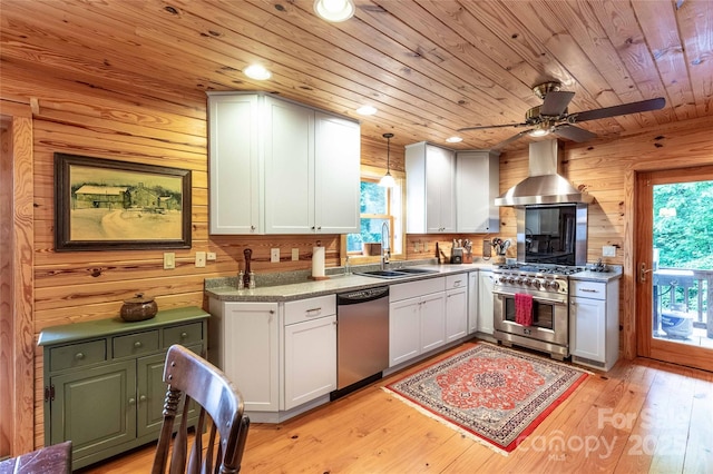 kitchen featuring wood ceiling, exhaust hood, ceiling fan, appliances with stainless steel finishes, and a sink