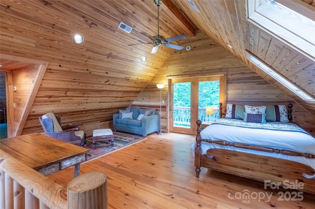 bedroom with wooden walls, access to outside, wooden ceiling, vaulted ceiling with beams, and hardwood / wood-style flooring