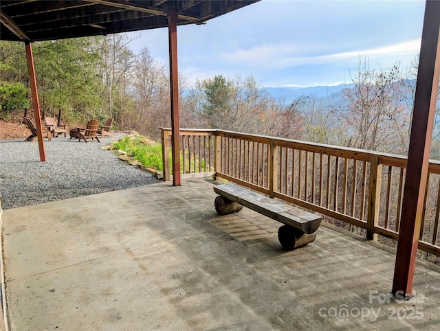 view of patio featuring a mountain view and an outdoor fire pit