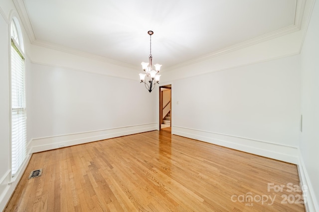 5232 Silchester Ln, Charlotte, NC 28215 - empty room featuring a chandelier, wood finished floors, crown molding, stairs, and baseboards