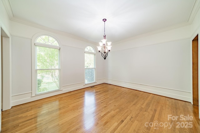 5232 Silchester Ln, Charlotte, NC 28215 - unfurnished room with a chandelier, light wood-type flooring, and crown molding