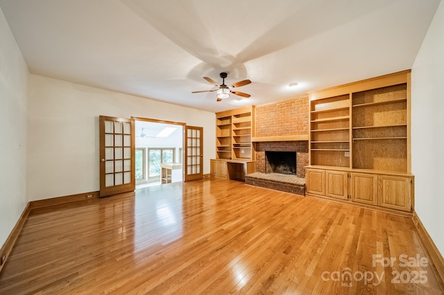 5232 Silchester Ln, Charlotte, NC 28215 - unfurnished living room featuring baseboards, ceiling fan, light wood-style flooring, and a brick fireplace