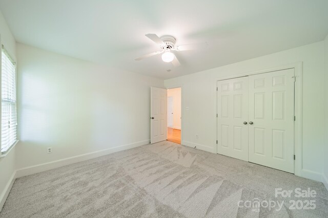 5232 Silchester Ln, Charlotte, NC 28215 - unfurnished bedroom featuring carpet, baseboards, a closet, and a ceiling fan
