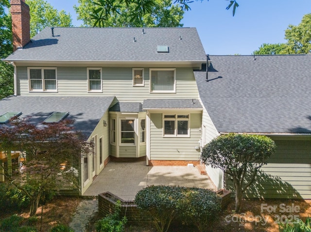 5232 Silchester Ln, Charlotte, NC 28215 - rear view of property featuring roof with shingles and a patio