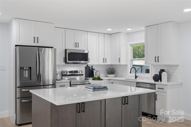 1315 Vickie Ln, Matthews, NC 28104 - kitchen featuring appliances with stainless steel finishes, a center island, white cabinets, and recessed lighting