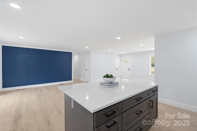 1315 Vickie Ln, Matthews, NC 28104 - kitchen with light wood finished floors, light countertops, a kitchen island, open floor plan, and recessed lighting