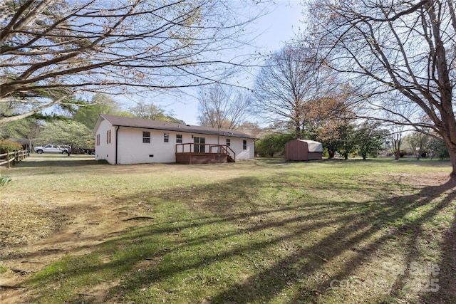 1315 Vickie Ln, Matthews, NC 28104 - view of grassy yard featuring a wooden deck and a shed