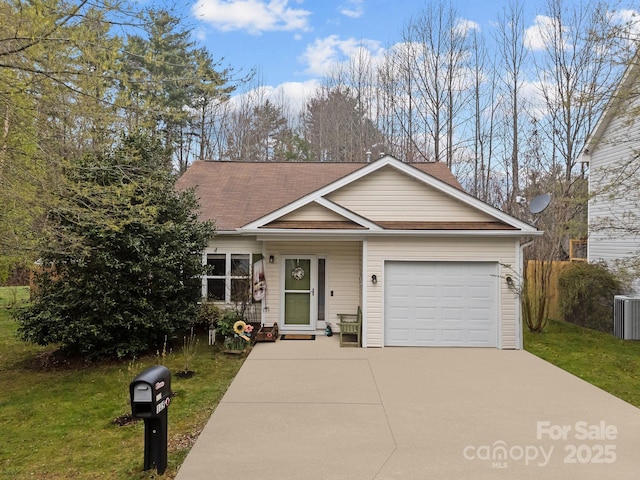 view of front of house with driveway, a front lawn, roof with shingles, and an attached garage