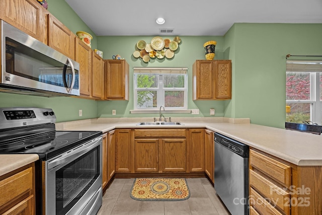 kitchen featuring a healthy amount of sunlight, visible vents, a sink, and stainless steel appliances