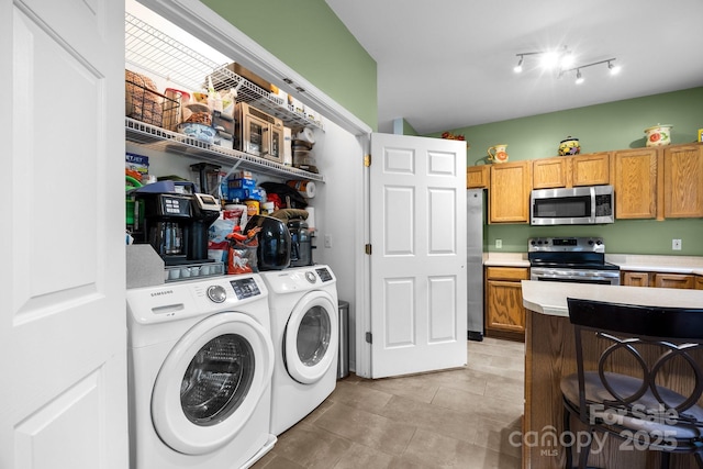 washroom with washer and clothes dryer and laundry area