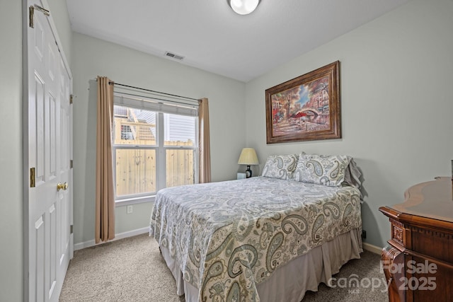 bedroom with a closet, carpet flooring, visible vents, and baseboards