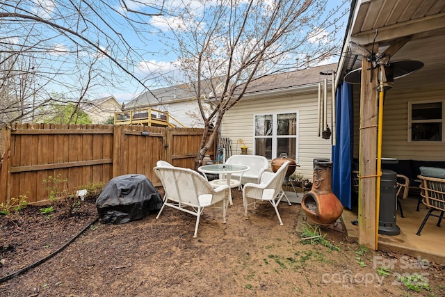 view of yard with a patio area, outdoor dining space, and fence