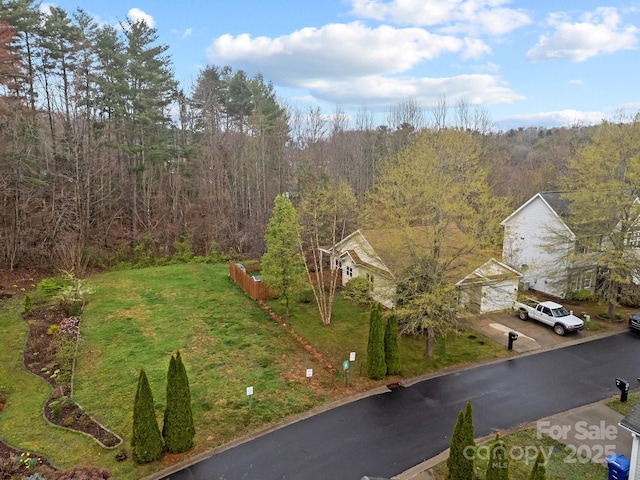 birds eye view of property featuring a wooded view