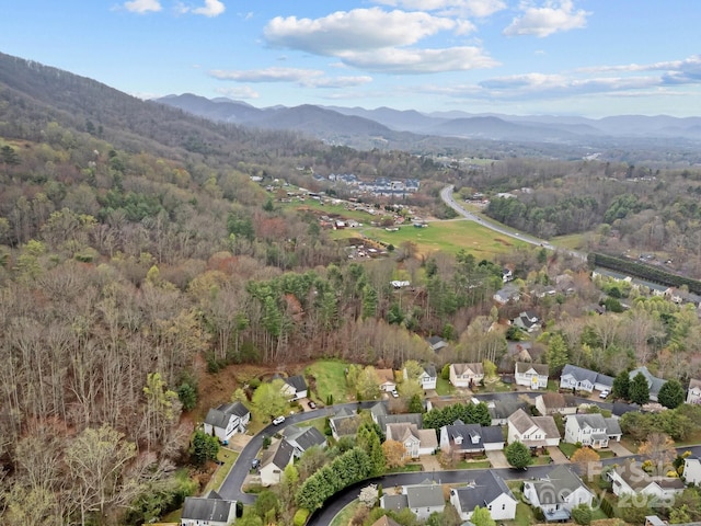 bird's eye view featuring a residential view, a wooded view, and a mountain view