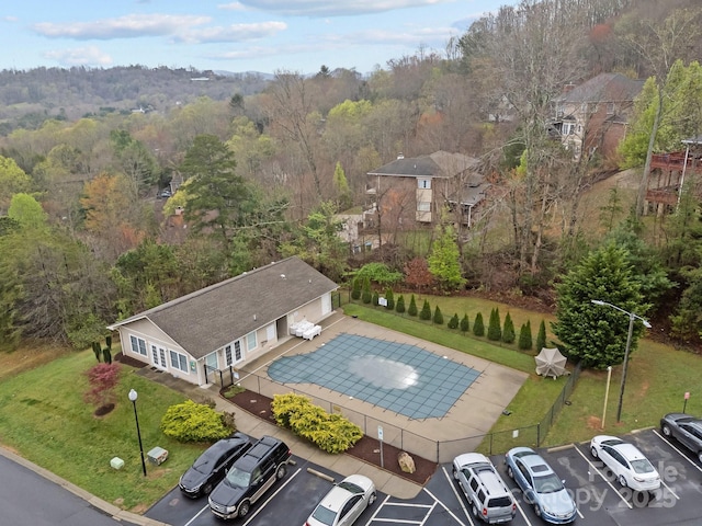 birds eye view of property with a view of trees
