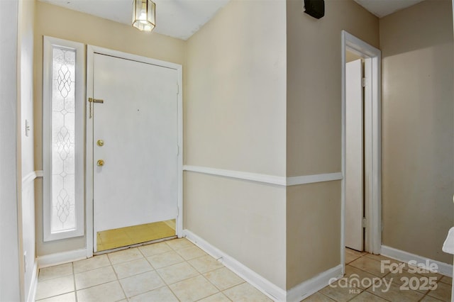 tiled entrance foyer with baseboards