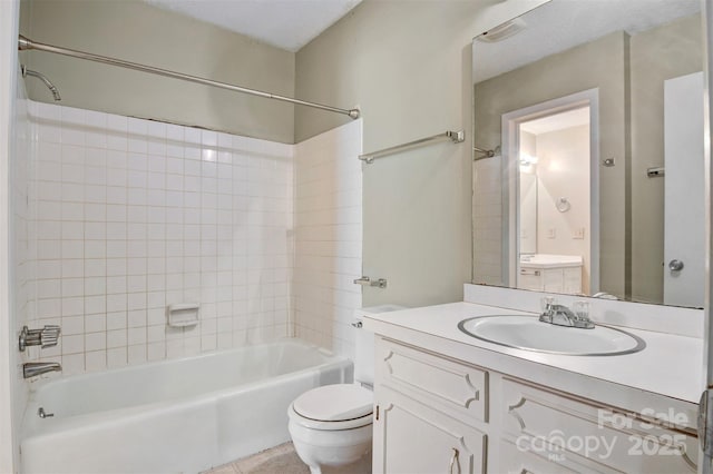 bathroom with shower / bath combination, vanity, toilet, and tile patterned floors