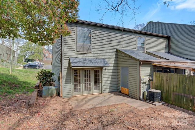 rear view of property featuring central AC, a patio, a shingled roof, and fence