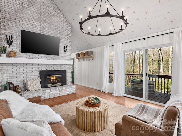 1469 Old Fort Rd, Fairview, NC 28730 - living room with high vaulted ceiling, a chandelier, wood finished floors, and a brick fireplace