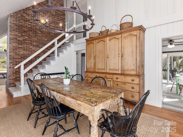 1469 Old Fort Rd, Fairview, NC 28730 - dining room with wood finished floors, stairs, high vaulted ceiling, and ceiling fan