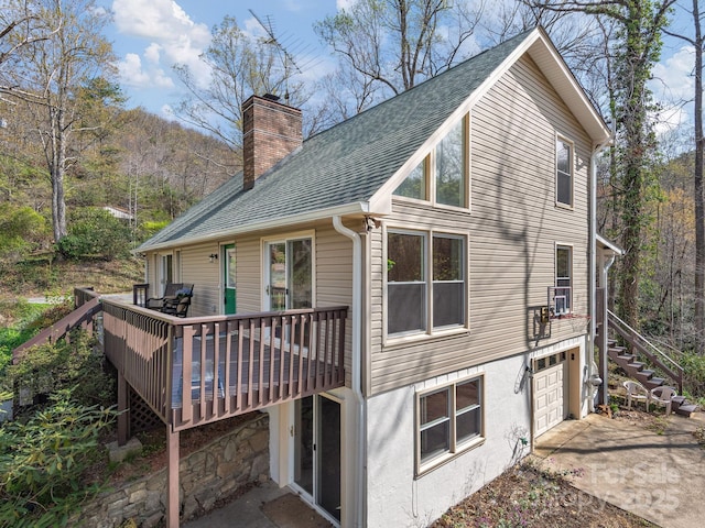 1469 Old Fort Rd, Fairview, NC 28730 - back of house featuring a chimney, driveway, stairs, roof with shingles, and a deck