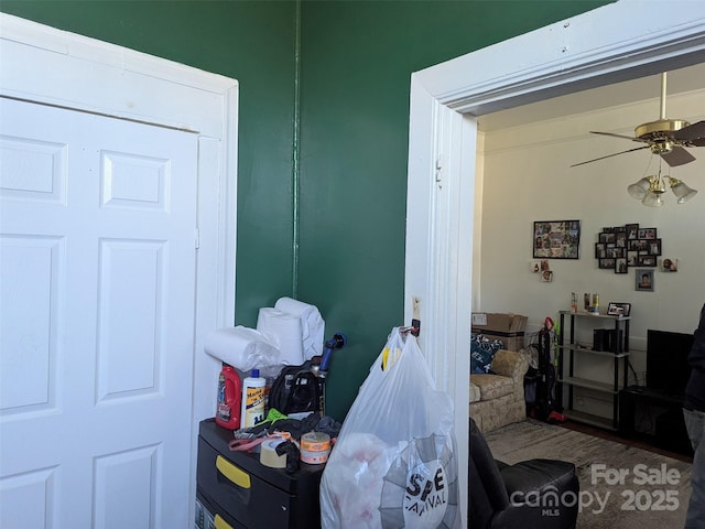 interior space with ceiling fan