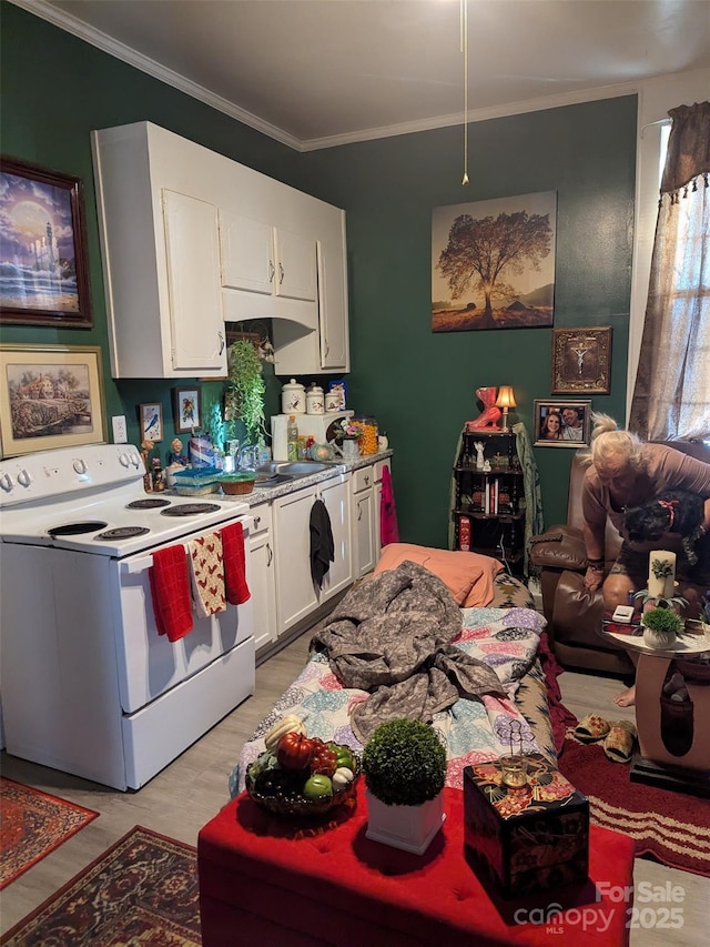 kitchen with white cabinets, white electric range oven, light wood-style floors, light countertops, and ornamental molding