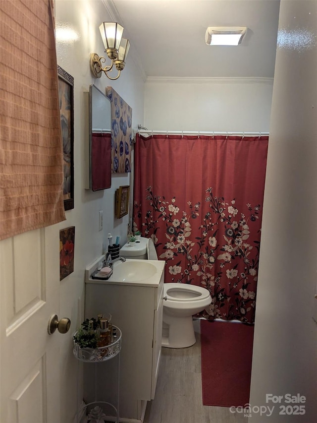bathroom featuring crown molding, vanity, toilet, wood finished floors, and a shower with curtain