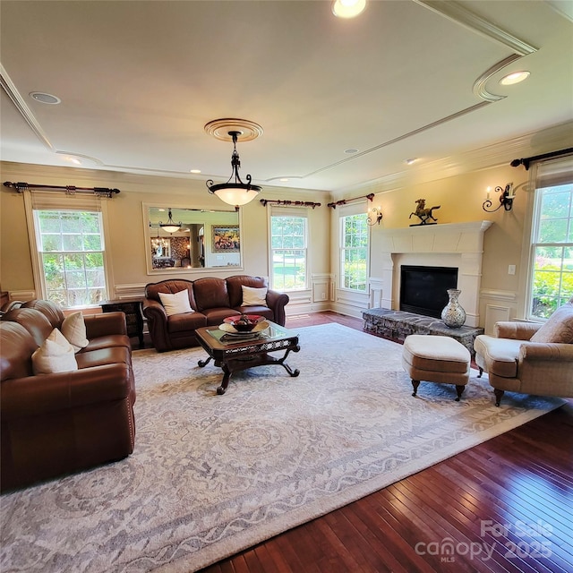 708 Ridgelake Dr, Weddington, NC 28104 - living room featuring hardwood / wood-style floors, crown molding, a fireplace with raised hearth, and recessed lighting
