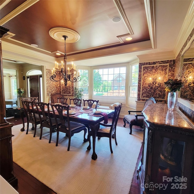 708 Ridgelake Dr, Weddington, NC 28104 - dining space featuring a raised ceiling, crown molding, wood finished floors, and a chandelier