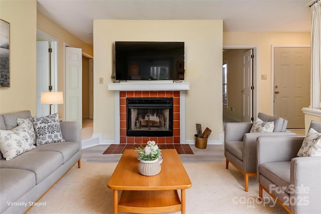 living room featuring wood finished floors and a tile fireplace