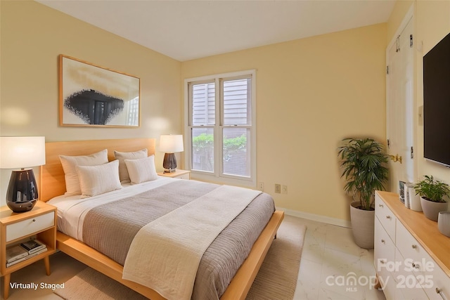 bedroom featuring baseboards