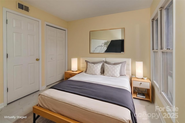 bedroom with a closet and visible vents