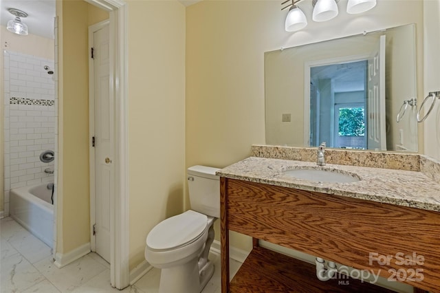 bathroom with toilet, marble finish floor, baseboards,  shower combination, and vanity