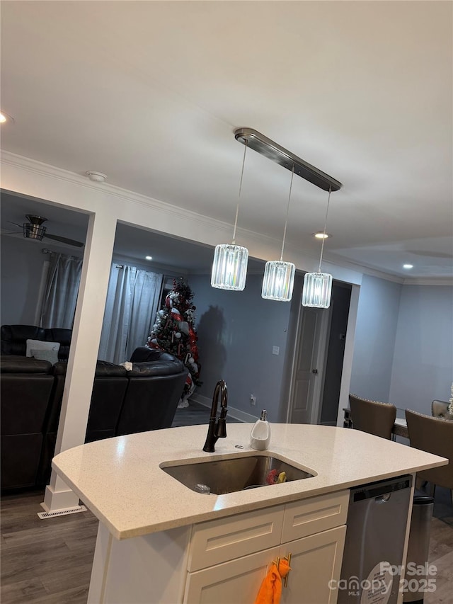 kitchen with a sink, dishwasher, a kitchen island with sink, white cabinetry, and open floor plan