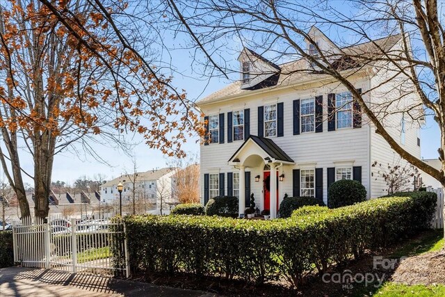 view of front of house with a gate and fence