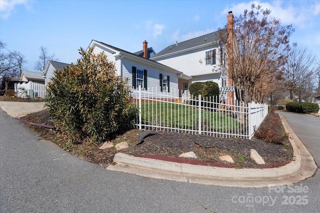 view of front of property with fence and a chimney