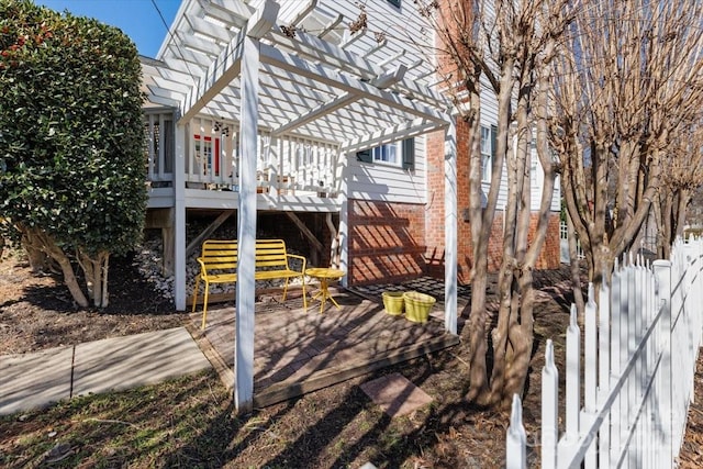 view of side of property featuring a pergola, a wooden deck, fence, and stairway