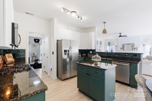 kitchen featuring green cabinets, visible vents, appliances with stainless steel finishes, white cabinetry, and a sink