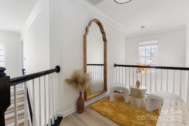 interior details featuring baseboards, wood finished floors, and crown molding