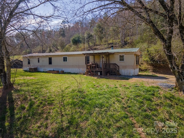 rear view of property featuring a yard